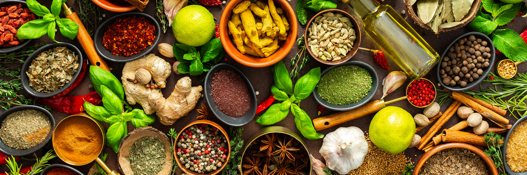 Assorted ground spices and whole spices in bowls